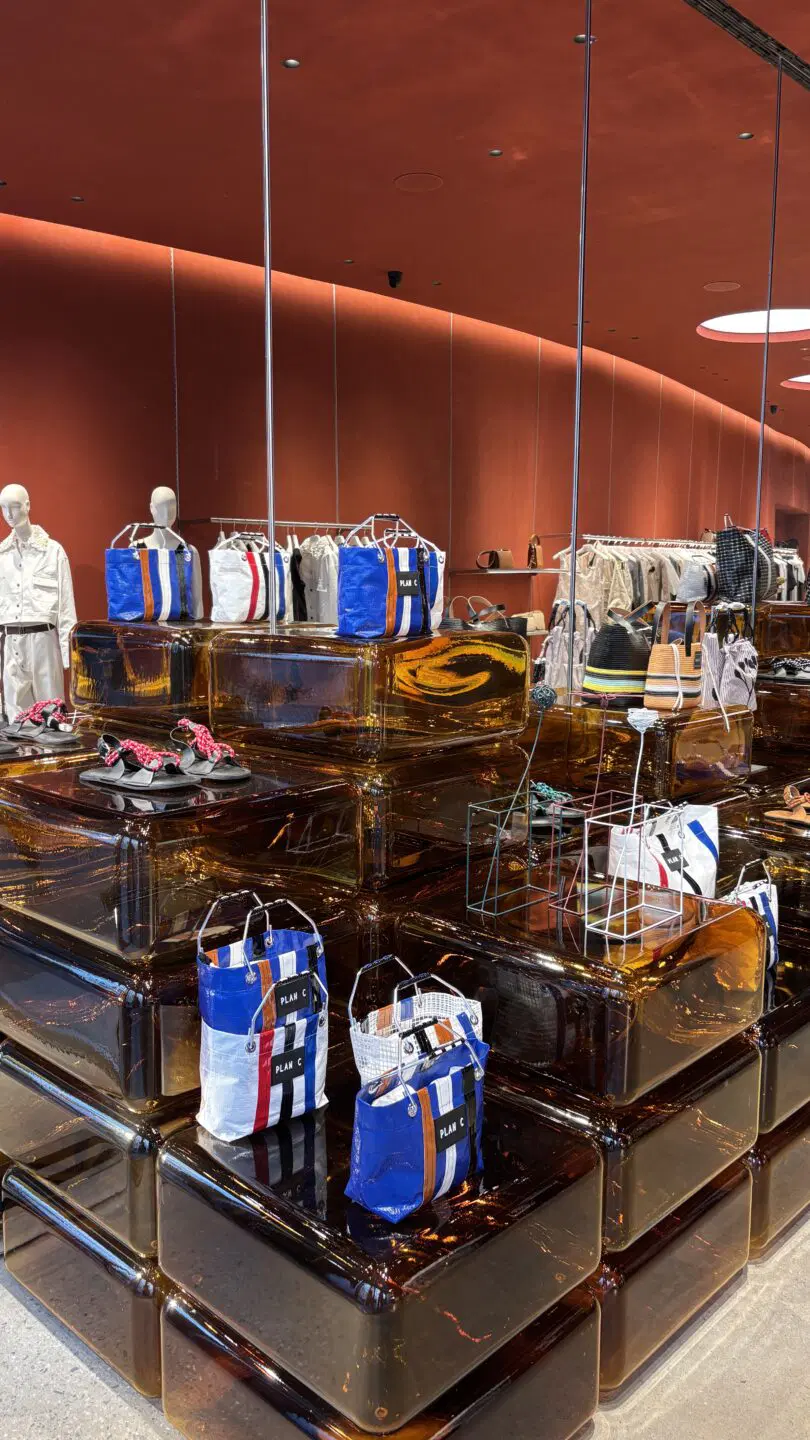 Inspiratieafbeelding van Milaan Design Week van een retro interieur voor retail, met het gebruik van oranje glas als display voor artikelen.