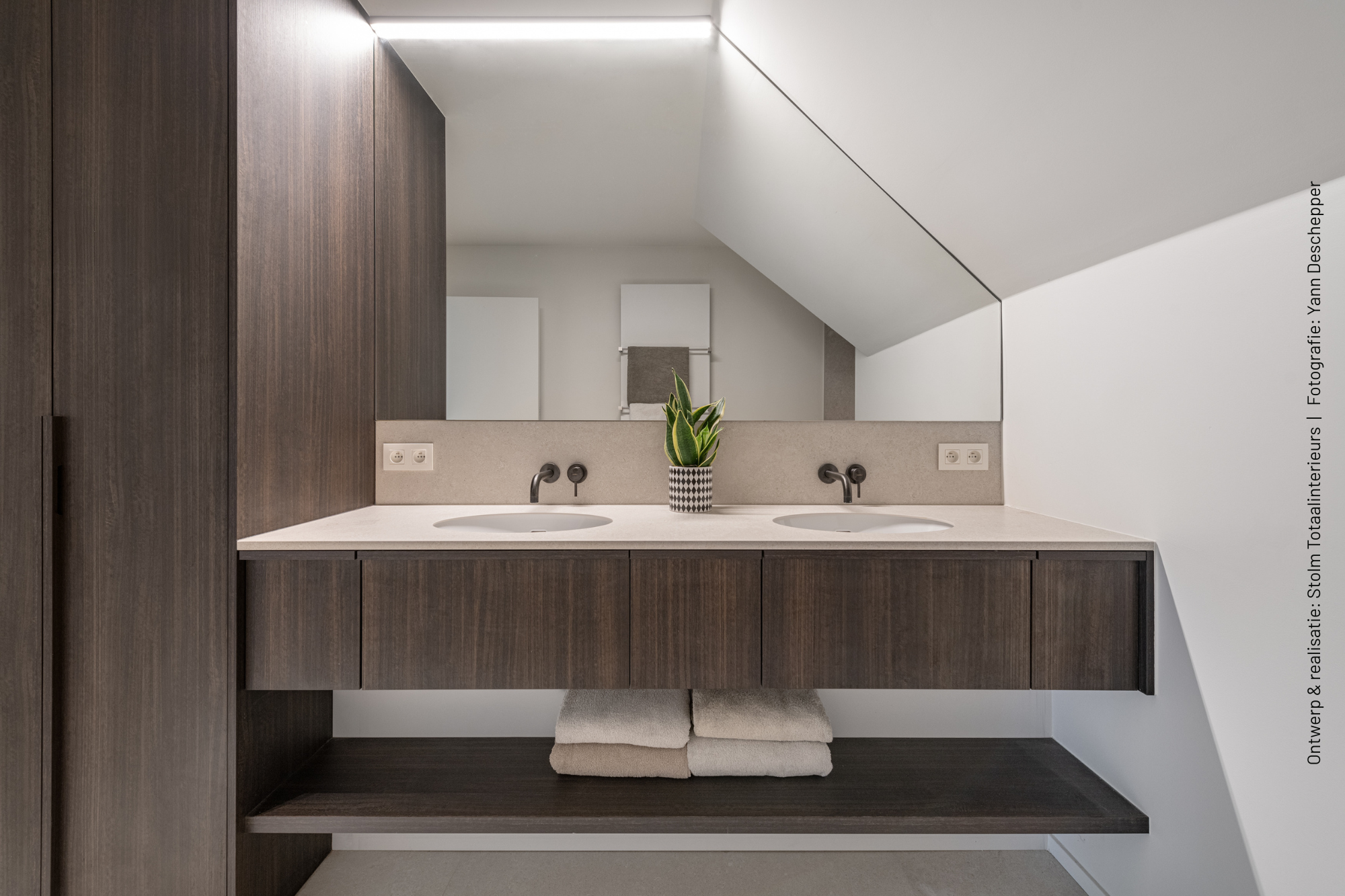 Gastenbadkamer met zwevend dubbel wastafelmeubel en hoge maatwerkkast in donkerbruin LR29 Sablé, gecombineerd met een licht werkblad.